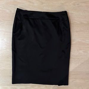 Womens black satin dress skirt with concealed back half zip and 2 vent slits.